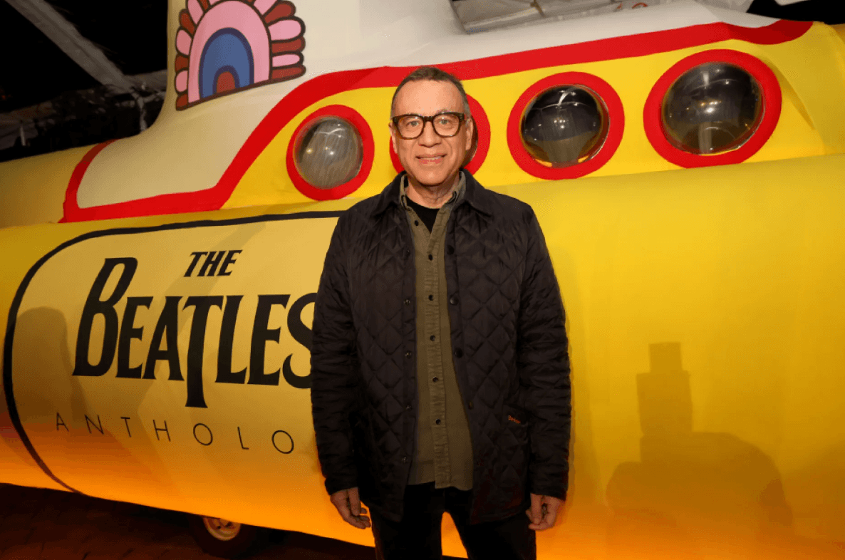 Fred Armisen in front of The Beatles yellow submarine
